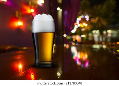 Beer On Bar With Night Scene In Background