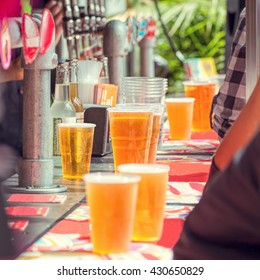 Beer And People At Outdoor Bar.