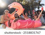 Beer, pool party and friends on flamingo, having fun and partying on new year. Summer celebration, water event or group portrait of drunk funny people laughing with alcohol, swimming or float on bird