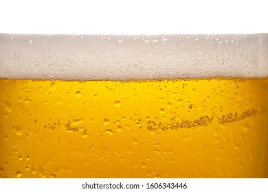  Beer poured into a glass with foam on top                               - Powered by Shutterstock