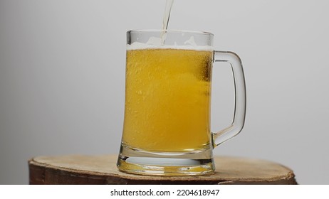 Beer is poured into a beer glass with a handle, a lot of bubbles and foam. 4k colorcorrected footage - Shutterstock ID 2204618947