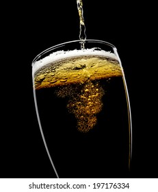 Beer Poured Into A Glass On A Black Background