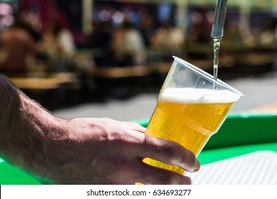 Beer Is Poured Into A Plastic Beaker.