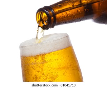 Beer Pouring Into Glass On White Background