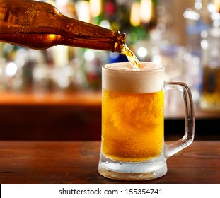 Beer Pouring Into Mug In A Bar