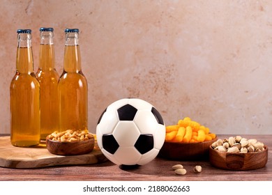 Beer And Snack On Wooden Table With Football Ball, Football Game Night Food