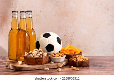 Beer And Snack On Wooden Table With Football Ball, Football Game Night Food