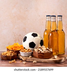 Beer And Snack On Wooden Table With Football Ball, Football Game Night Food