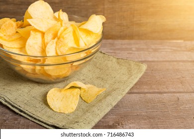 beer snacks potato chips and nuts in a sack on wooden background