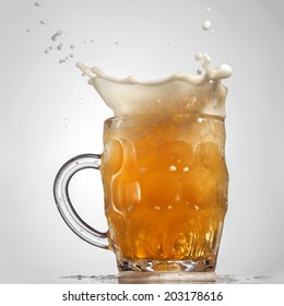 Beer Splash In Glass Isolated On White Background