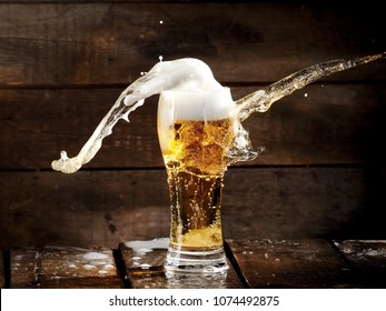 Beer splash on wood - Powered by Shutterstock