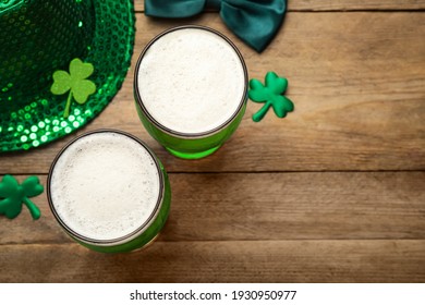 Beer and St Patrick's Day decor on wooden table, flat lay. Space for text