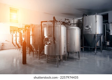 beer tanks at the brewery with modern equipment - Shutterstock ID 2257974435
