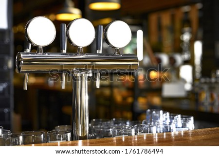 Beer tap in bar, mock up with selective focus.