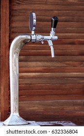 Beer Tap Chromeplated, Against The Background Of A Wooden Wall.