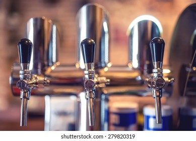 Beer Tap At Restaurant, Bar Or Pub. Close-up Details Of Beer Draft Taps In A Row 