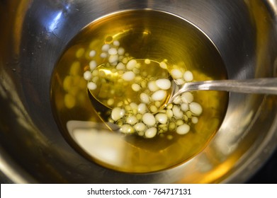 Beeswax In The Process Of Melting Into A Liquid, In A Metal Bowl Submerged In A Double Boiler.