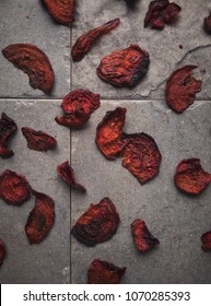 Beet chips on slate surface imitating rose petals