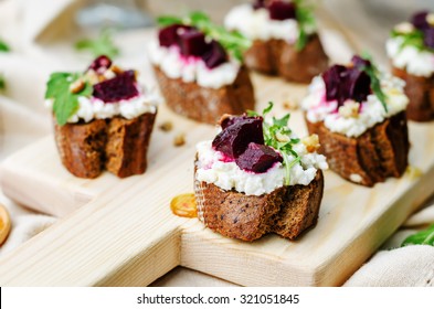 Beet Goat Cheese Arugula Walnut Honey Crostini. Toning. Selective Focus