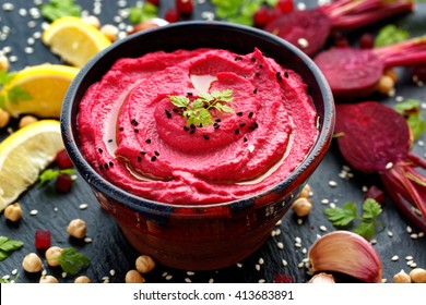 Beet hummus, creamy and delicious in a ceramic bowl