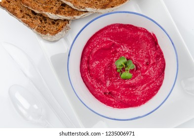 beet hummus in portions served with whole grain bread