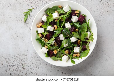 beetroot, arugula, feta cheese and walnut salad, top view - Shutterstock ID 748701319