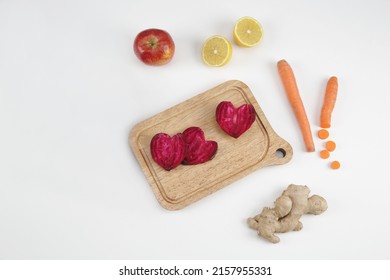 beetroot carrot lemon ginger on wooden board