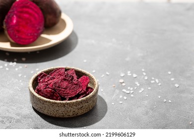 Beetroot chips in a bowl on a gray background. Healthy vegetable chips, snack for vegetarians, copy space for text - Powered by Shutterstock