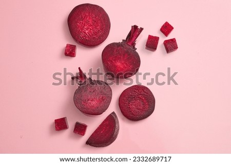 Beetroot cut in halves, slices and cubes are decorated against pink background. Beetroot (Beta vulgaris) can help people with heart failure and heart disease