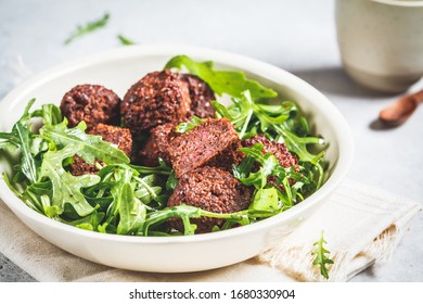 Beetroot Falafel With Arugula Leaves In A White Bowl. Healthy Vegan Food Concept.