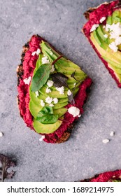 Beetroot hummus toast with avocado and ricotta cheese healthy snack flatlay style food photography