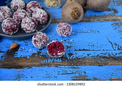 Beetroot Quinoa Date Almond Coconut Protein Balls On Blue Wooden Background, Selective Focus