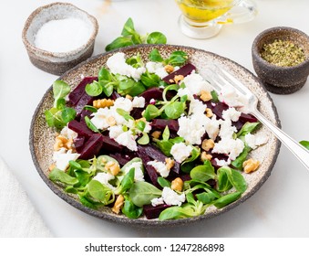 Beetroot Salad With Feta, Cheese, Walnuts, Corn Salad On White Table, Side View