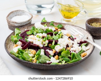 Beetroot Salad With Feta, Cheese, Walnuts, Corn Salad On White Table, Side View