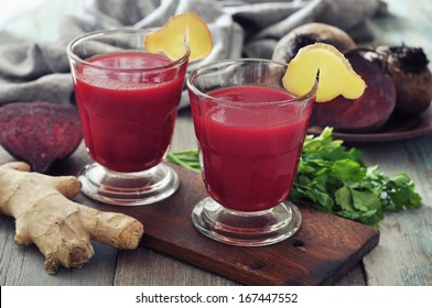 Beetroot smoothie in glass with ginger and  fresh vegetables on wooden background - Powered by Shutterstock