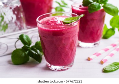 Beetroot smoothies in glass with basil on a wooden background. Selective focus. - Powered by Shutterstock