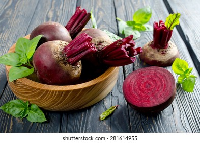 Beets and Basil leaves on wooden table