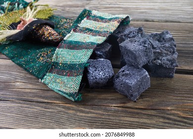 Befana sock with sweet coal and candy on wooden background. Italian Epiphany day tradition. - Powered by Shutterstock