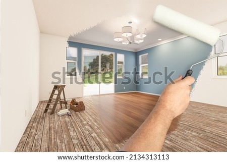Before and After of Man Painting Roller to Reveal Newly Remodeled Room with Fresh Blue Paint and New Floors. Foto d'archivio © 