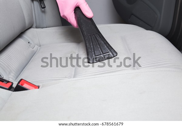 Before chemical cleaning process a professionally nozzle\
releasing a car textile seats from dust. Early spring cleaning or\
regular clean up. 