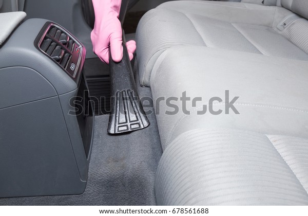 Before chemical cleaning process a professionally\
nozzle releasing a car floor from dust and sand. Early spring\
cleaning or regular clean up.\
