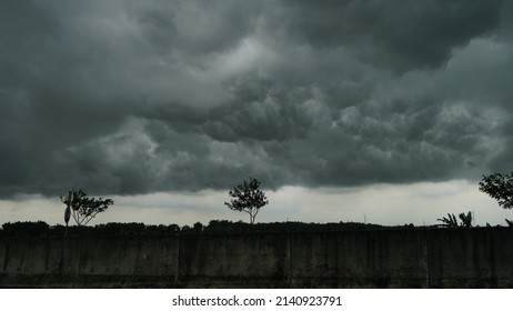 Before the heavy rainstorm. The sky was completely covered with clouds. Lots of lightning and strong winds. The dark clouds look like huge black smoke from an erupting volcano - Shutterstock ID 2140923791