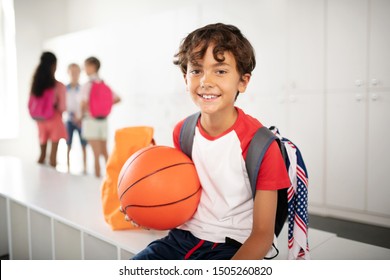 Before PE Class. Cheerful Schoolboy Holding Basketball Ball Feeling Excited Before PE Class