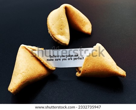 Before you judge me, make sure you are perfect. Cracked chinese fortune cookie with motivational message.