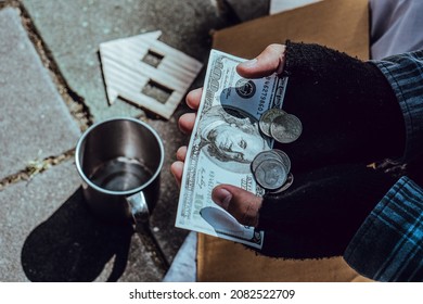 Beggar,Hand Of Homeless Adult Man Holding Money That Receive Form Poeple On Street. Indifference Of People. Social Issues.Closeup Concept.