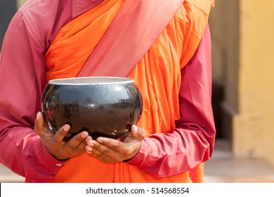 A Begging Bowl In The Hands Of A Buddhist Monk