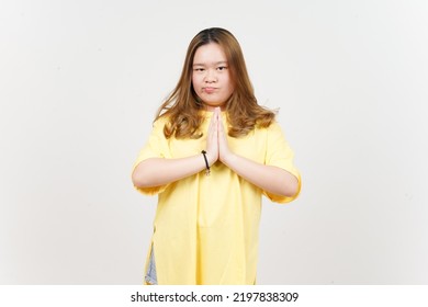 Begging to say sorry of Beautiful Asian Woman wearing yellow T-Shirt Isolated On White Background