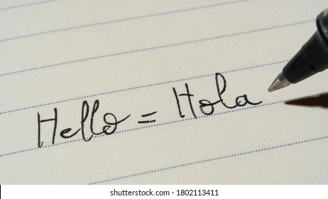 Beginner Spanish Language Learner Writing Hello Word Hola For Homework On A Notebook Macro Shot