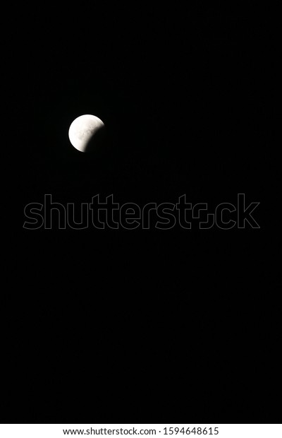 The beginning\
of eclipse process late at\
night