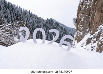 Beginning of a new year. Changes 2026. Concept of new ideas, beginning of a new year, planning and setting goals to achieve new heights and successes in life. 2026 against the backdrop of mountains.